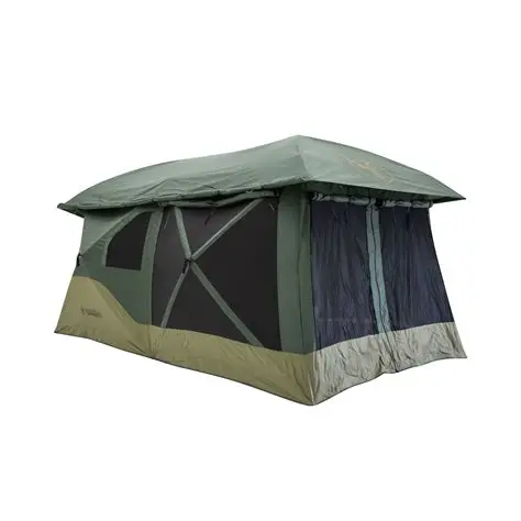 Gazelle T4 Plus Hub Tent Overland Edition set up in a forest campsite with screened porch, outdoor rug, captain’s chairs, and a small table inside.
