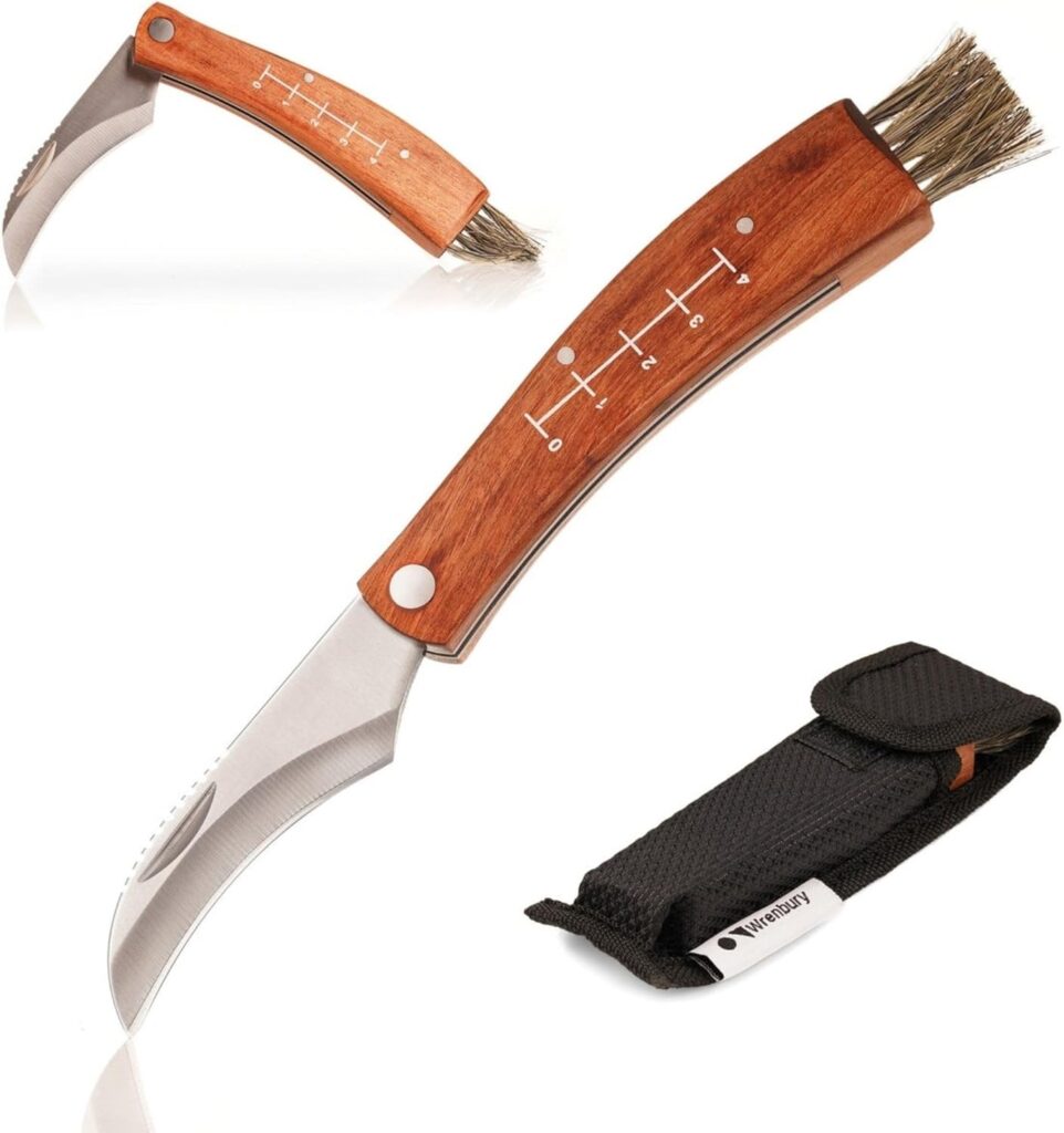 Folding mushroom knife with curved blade and natural bristle brush resting on rustic wood, used by foragers for clean and respectful wild mushroom harvesting.
