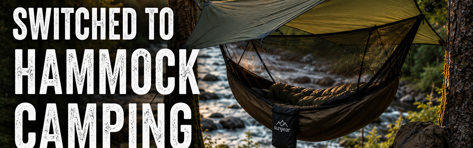 Forest hammock camping setup beside a river during golden hour with tarp shelter and backpack